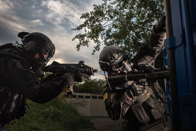 Two SWAT members wearing the Tactical Air-Purifying Respirator mask (TAPR)