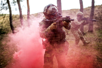 Soldier going through dense smoke while wearing the CM-7M military grade gas mask