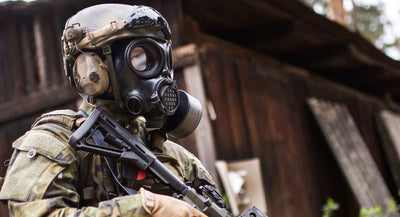 Solider standing sideways while wearing the CM-7M military gas mask
